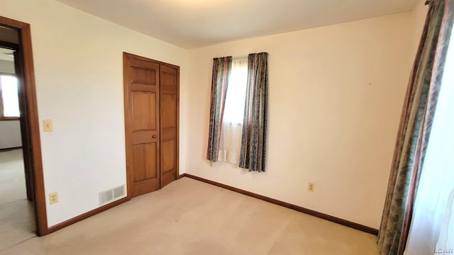 9683 Springville Hwy, Onsted, MI 49265 - unfurnished bedroom featuring baseboards, visible vents, light carpet, and a closet