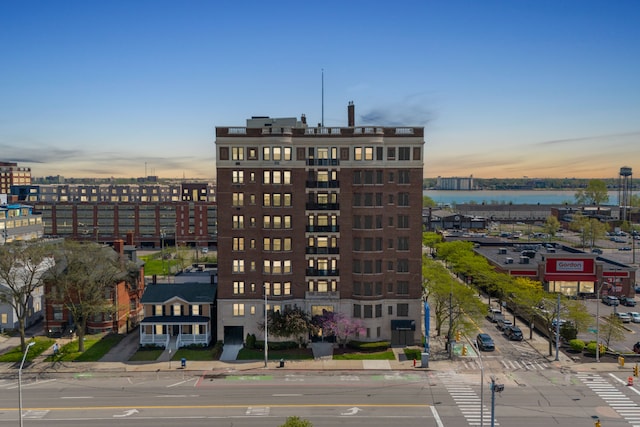 property at dusk with a water view