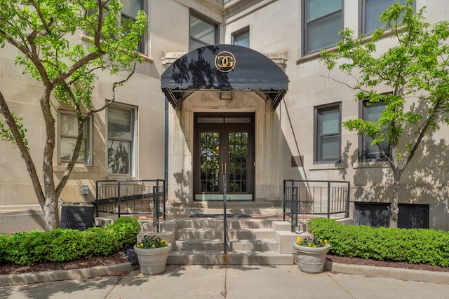 view of exterior entry featuring french doors
