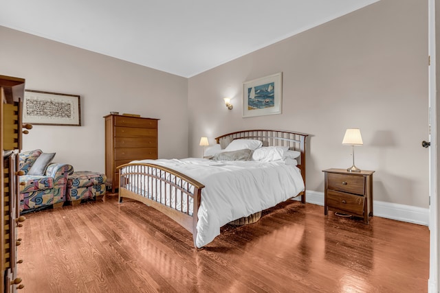 bedroom featuring wood finished floors and baseboards