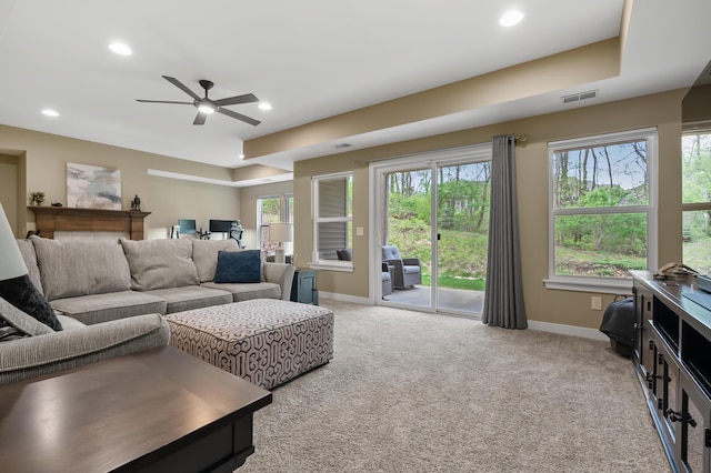 living area featuring ceiling fan, visible vents, light colored carpet, baseboards, and recessed lighting