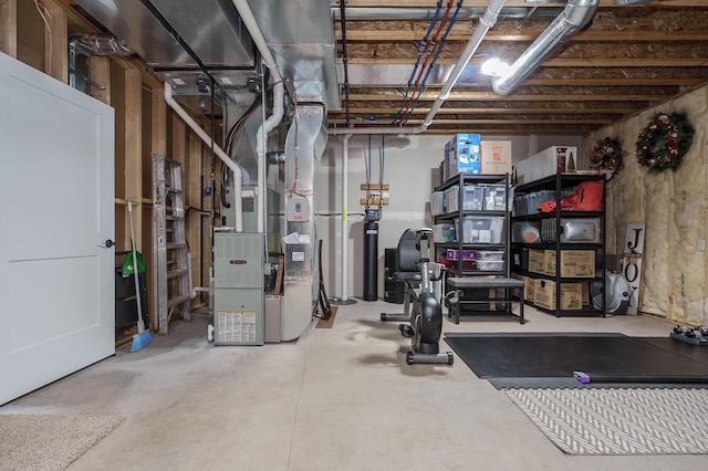 unfinished basement featuring heating unit