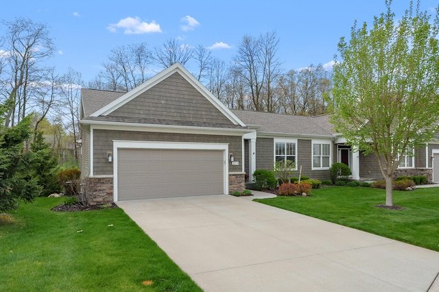 view of front of property with driveway, roof with shingles, a front lawn, an attached garage, and stone siding