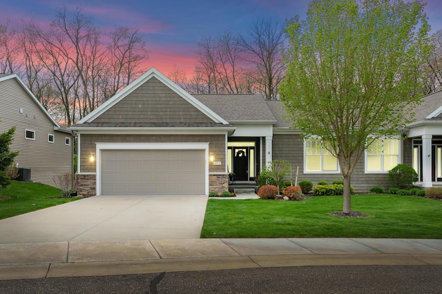 craftsman inspired home with concrete driveway, a front lawn, stone siding, and a garage