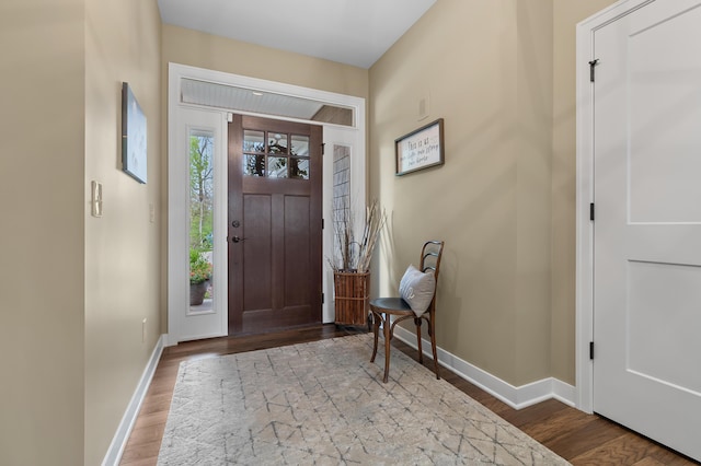 entrance foyer featuring baseboards and wood finished floors