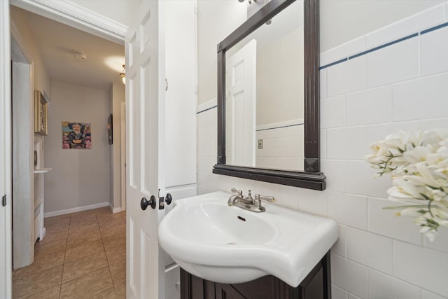 bathroom with baseboards, a sink, and tile patterned floors