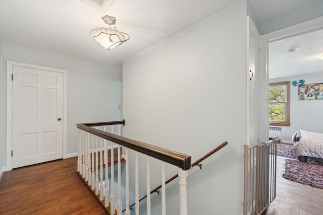 stairs featuring radiator, baseboards, and wood finished floors