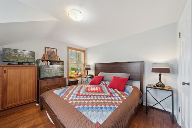 bedroom featuring wood finished floors and vaulted ceiling