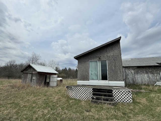 rear view of property featuring an outdoor structure