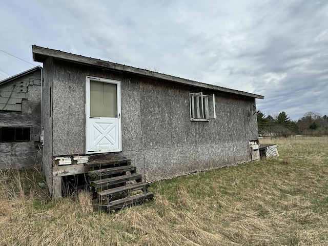 view of home's exterior featuring a yard and entry steps