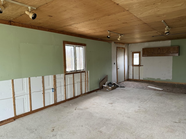 unfurnished room with rail lighting and wooden ceiling