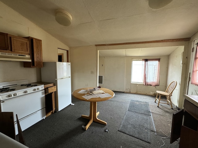 kitchen with carpet, under cabinet range hood, brown cabinets, and white appliances