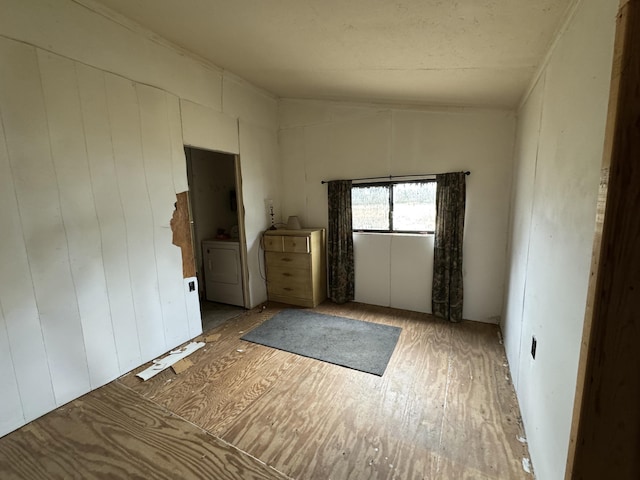 unfurnished room with washing machine and dryer and lofted ceiling