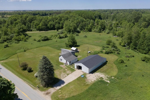 birds eye view of property featuring a rural view and a wooded view