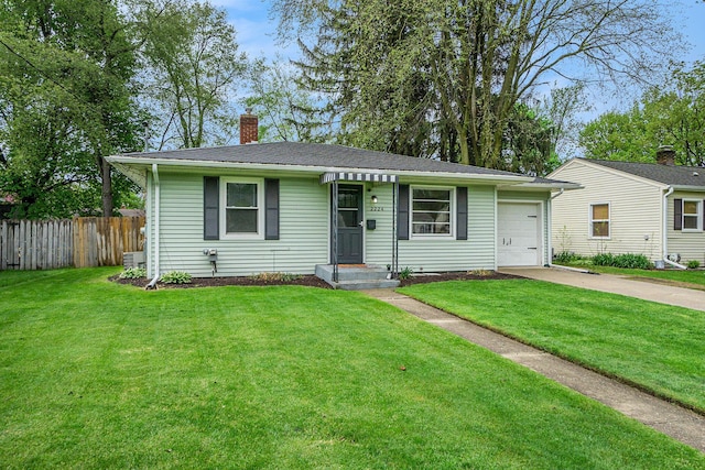 view of front of house with fence, a chimney, driveway, and a front lawn