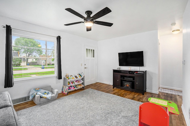 game room with a ceiling fan, baseboards, visible vents, and wood finished floors