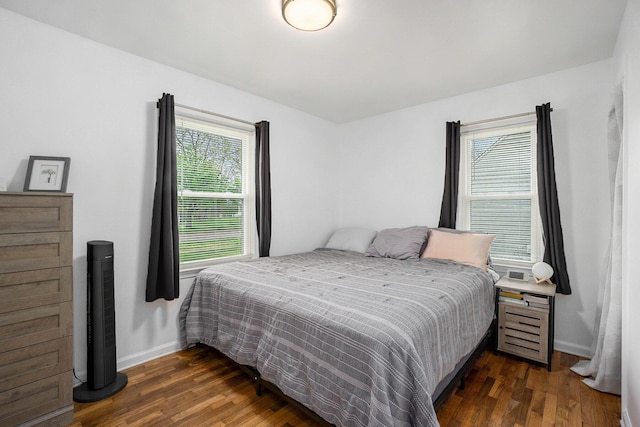 bedroom with baseboards and wood finished floors