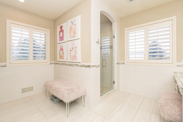 3960 Harvest Creek Ct, Rochester, MI 48306 - full bath featuring tile walls, a wealth of natural light, a shower stall, and visible vents