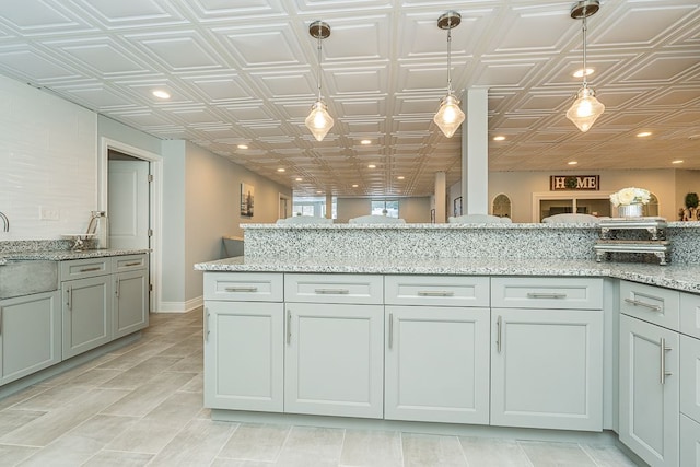 3960 Harvest Creek Ct, Rochester, MI 48306 - kitchen featuring light stone countertops, recessed lighting, and decorative light fixtures