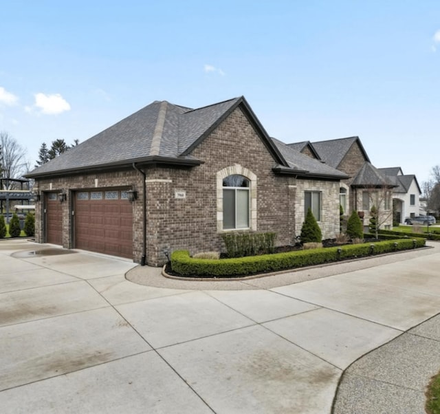 3960 Harvest Creek Ct, Rochester, MI 48306 - view of property exterior featuring brick siding, a garage, roof with shingles, and concrete driveway