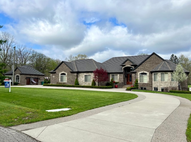 3960 Harvest Creek Ct, Rochester, MI 48306 - french country inspired facade with a front yard, curved driveway, stone siding, and cooling unit