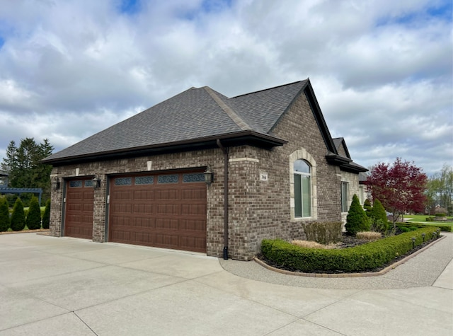 3960 Harvest Creek Ct, Rochester, MI 48306 - view of side of property with a garage, a shingled roof, concrete driveway, and brick siding