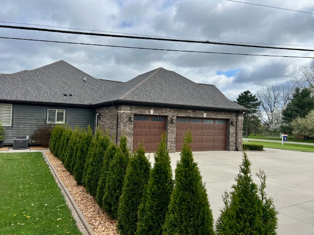 3960 Harvest Creek Ct, Rochester, MI 48306 - view of side of property with a garage, central AC, roof with shingles, brick siding, and concrete driveway