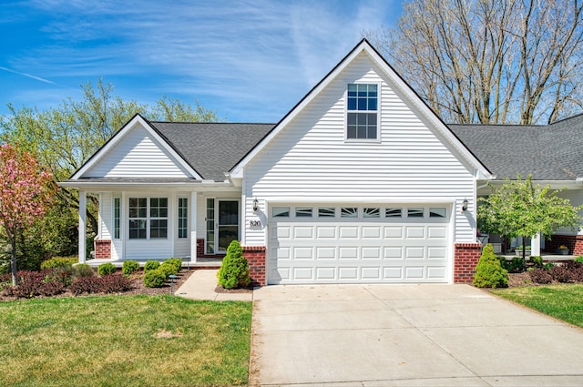 traditional home with brick siding, a front yard, concrete driveway, roof with shingles, and a garage