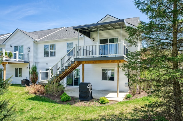 rear view of property with central AC, stairway, a yard, and a patio area