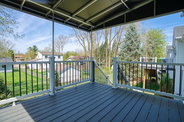 deck with a lawn and a residential view