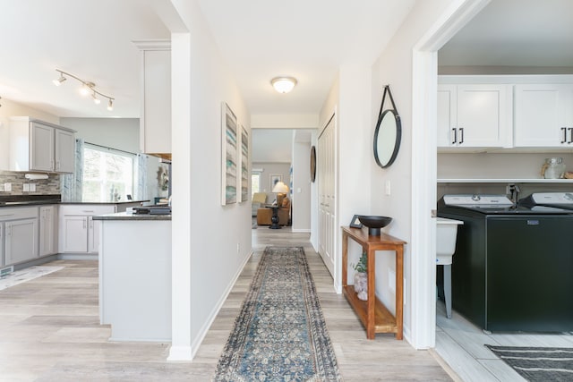 hall featuring separate washer and dryer and light wood-style floors