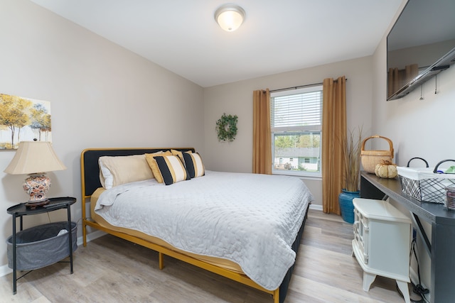 bedroom with light wood-style floors and baseboards