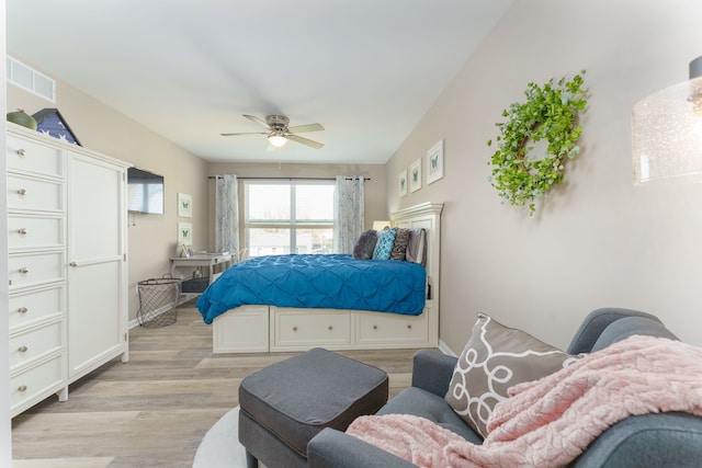 bedroom featuring light wood finished floors, a ceiling fan, and baseboards