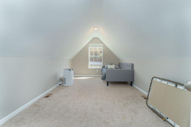 carpeted bedroom featuring baseboards and vaulted ceiling