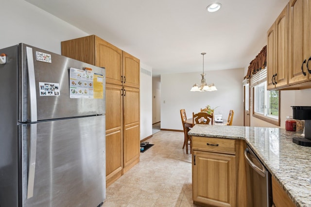 kitchen with hanging light fixtures, light stone countertops, a peninsula, a notable chandelier, and stainless steel appliances