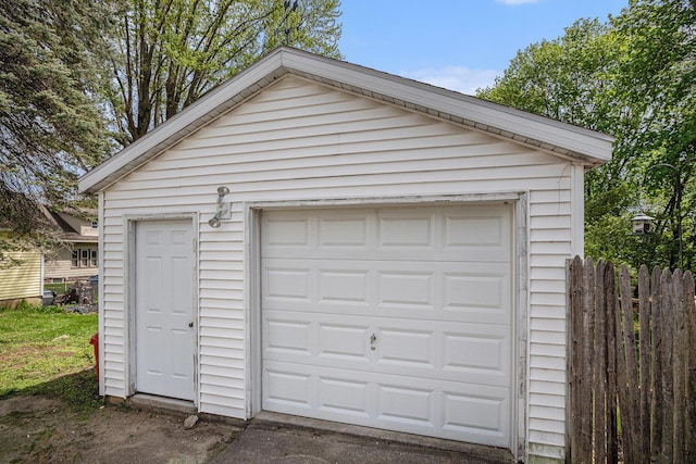 detached garage featuring fence