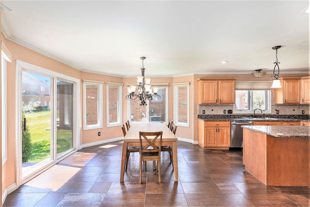 kitchen featuring baseboards, backsplash, a chandelier, and dishwasher