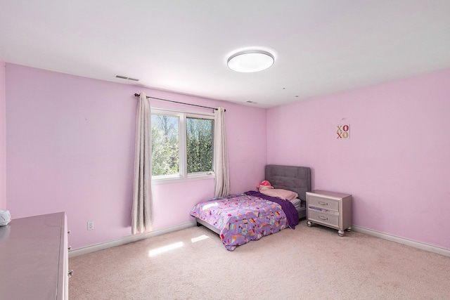 bedroom with light colored carpet, baseboards, and visible vents