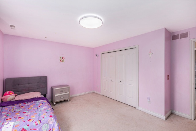 bedroom with baseboards, visible vents, and light carpet