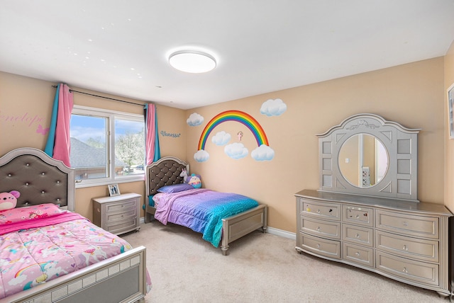 bedroom with baseboards and light colored carpet