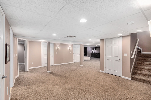 finished below grade area with carpet floors, baseboards, and stairs