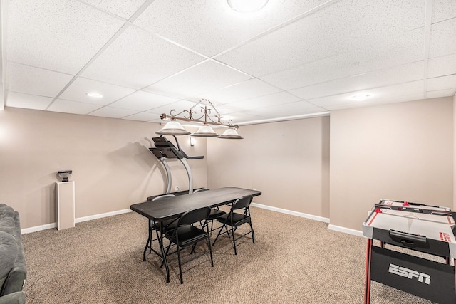 rec room with carpet floors, baseboards, and a drop ceiling