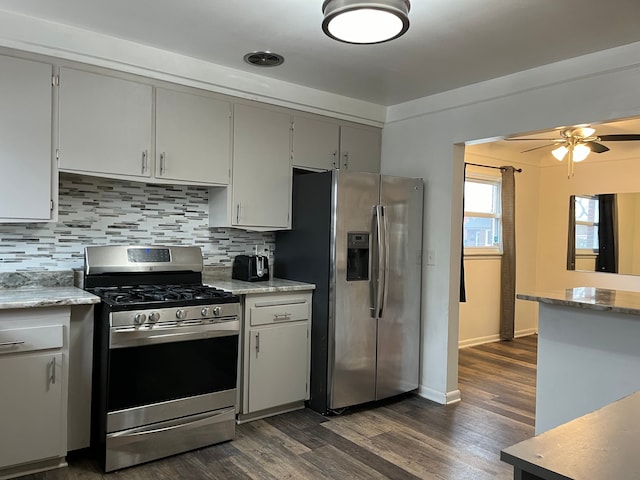 kitchen with decorative backsplash, baseboards, ceiling fan, dark wood finished floors, and appliances with stainless steel finishes