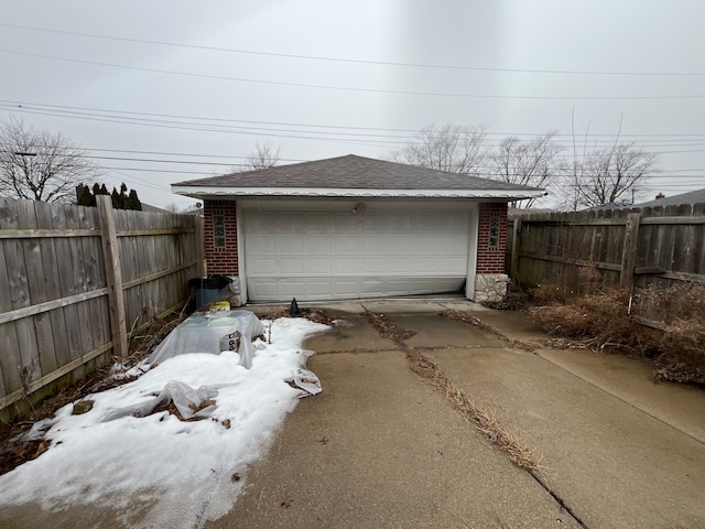 detached garage featuring fence