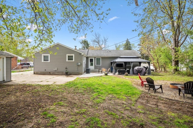 rear view of house with a patio, a gazebo, a fire pit, and central AC
