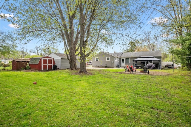 view of yard with an outdoor structure, a patio area, and a storage unit