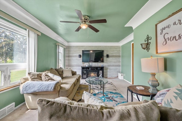 living area with baseboards, visible vents, and carpet