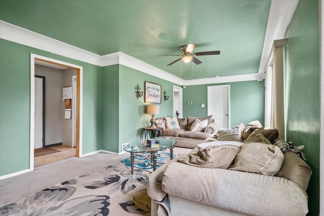 living room with baseboards, ceiling fan, and carpet flooring