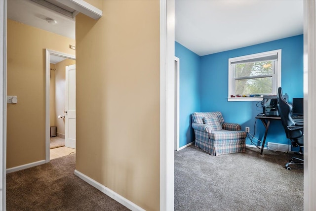 carpeted home office featuring baseboards and visible vents