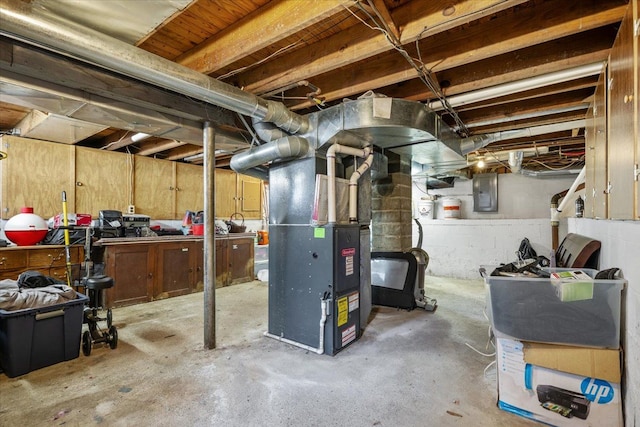 unfinished basement with heating unit and electric panel
